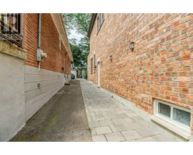 A narrow alleyway between two brick buildings.