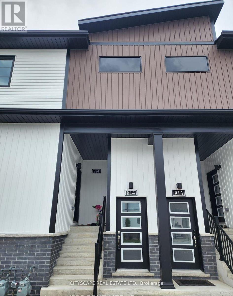 A house with a white and brown exterior and a black door.