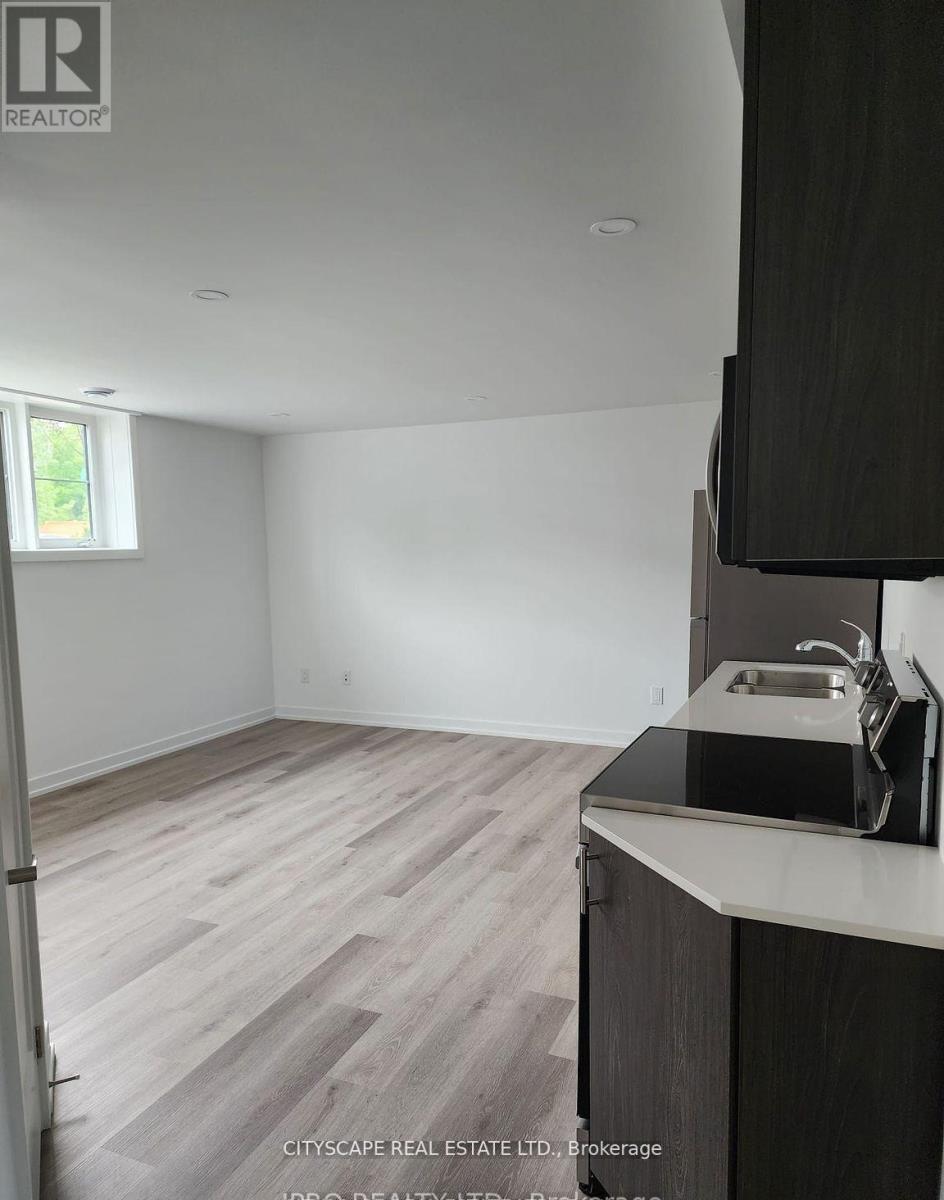 A kitchen with a sink and a window.