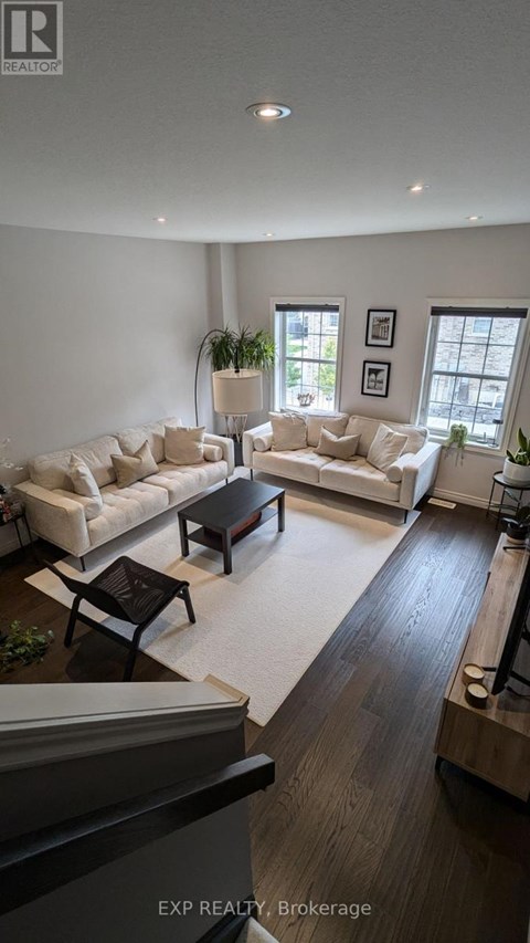 A living room with a white couch and a coffee table.