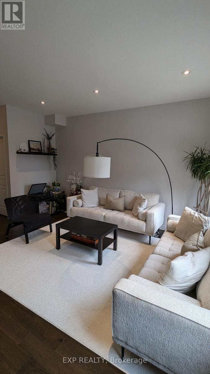A living room with a black piano and white sofas.
