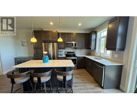 A kitchen with a table and chairs in front of it.