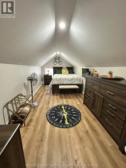 A bedroom with a bed, dresser, and a bicycle on the wall.