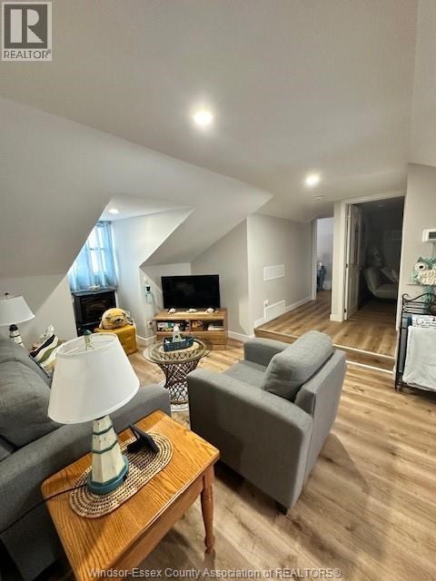 A living room with a grey couch and a wooden coffee table.