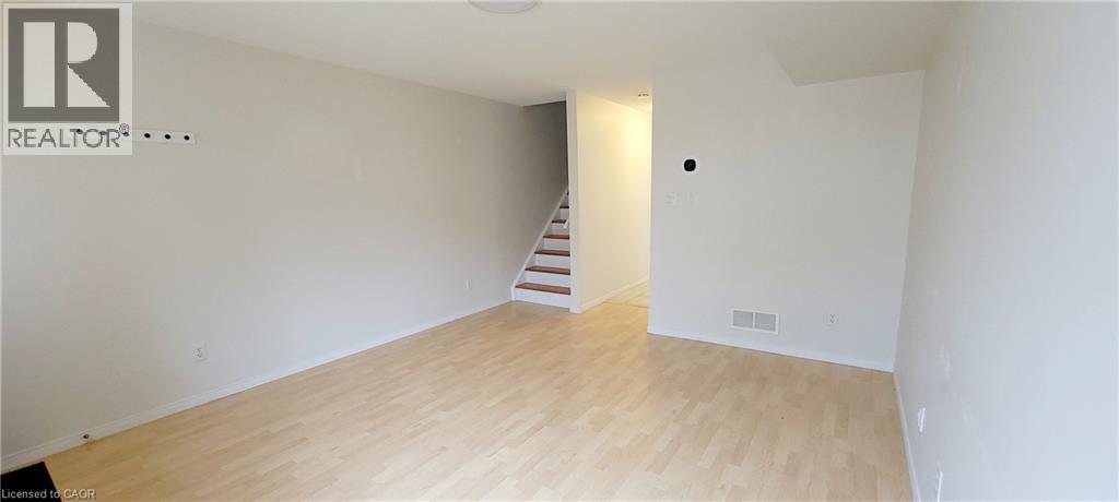 A room with a staircase leading to another room.