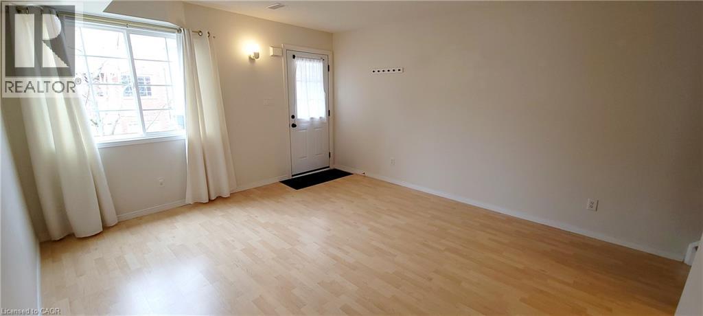 A room with a door and a window with curtains.