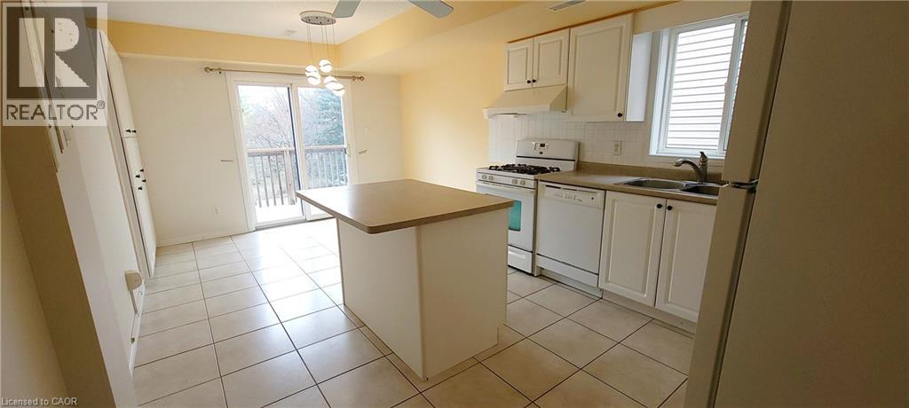 A kitchen with white cabinets and a brown counter.