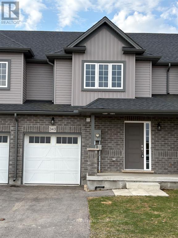 House number 343 with a grey roof and a white garage door.