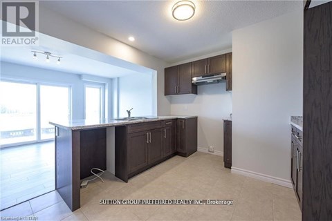 A kitchen with dark wood cabinets and a white countertop.