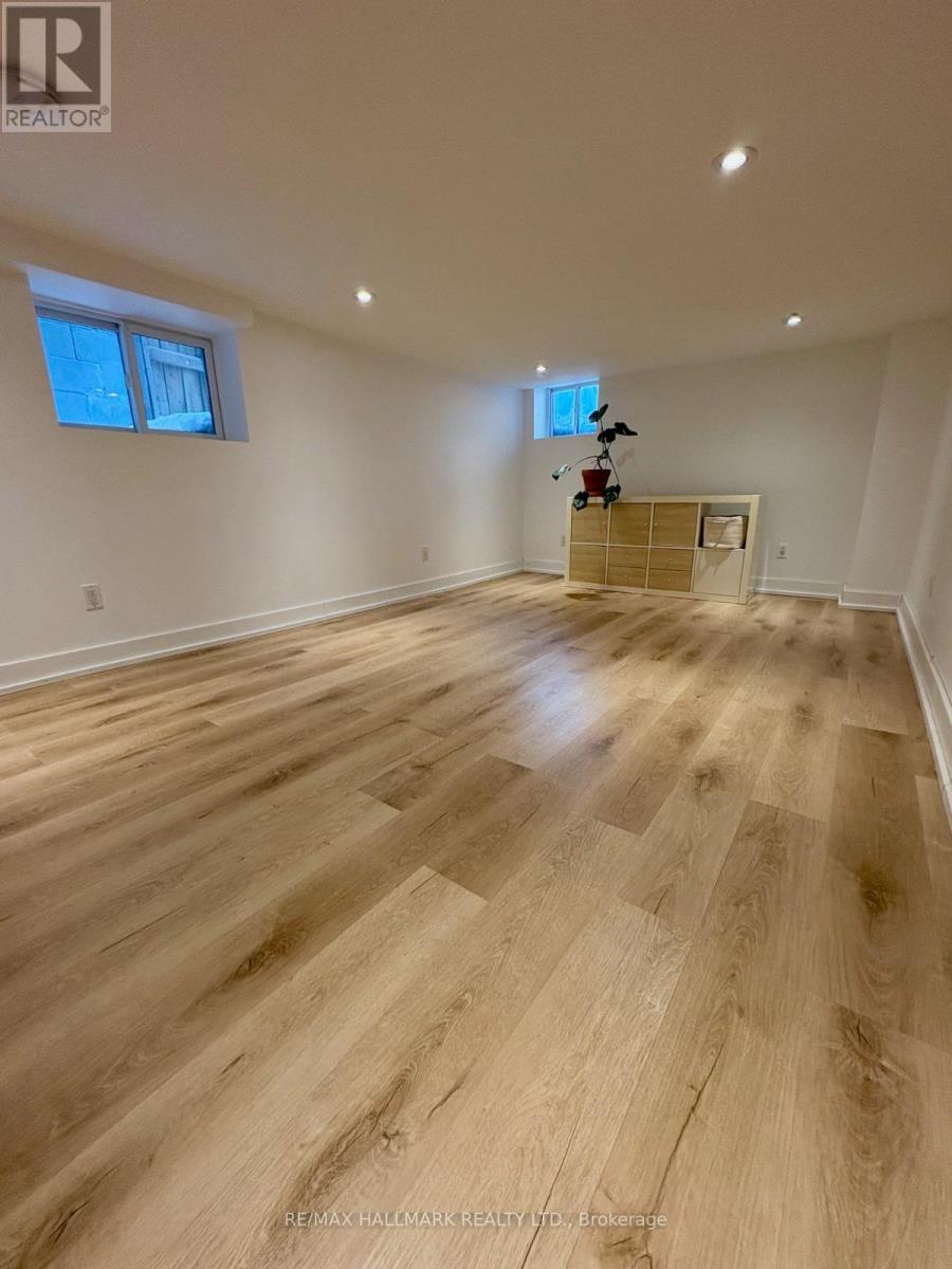 A room with wooden flooring and a window.