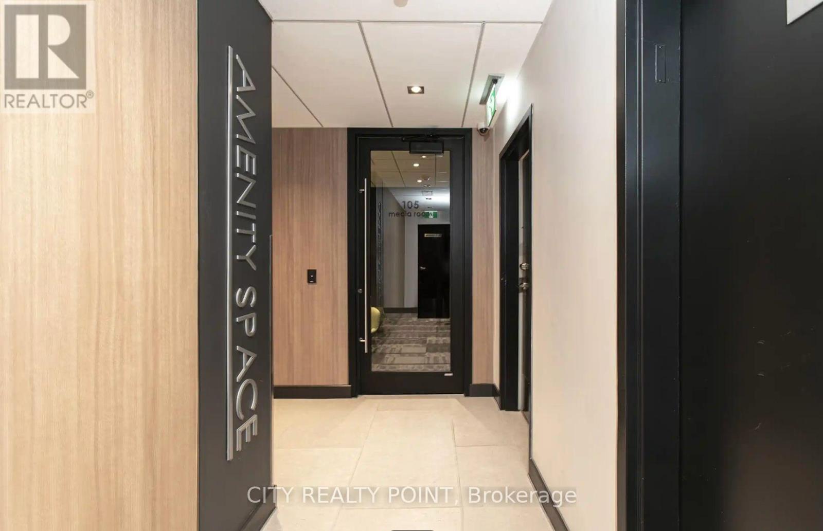 A hallway with a sign that says "Amenity Space" on the left side.