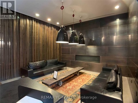 A modern living room with a black couch and a wooden coffee table.