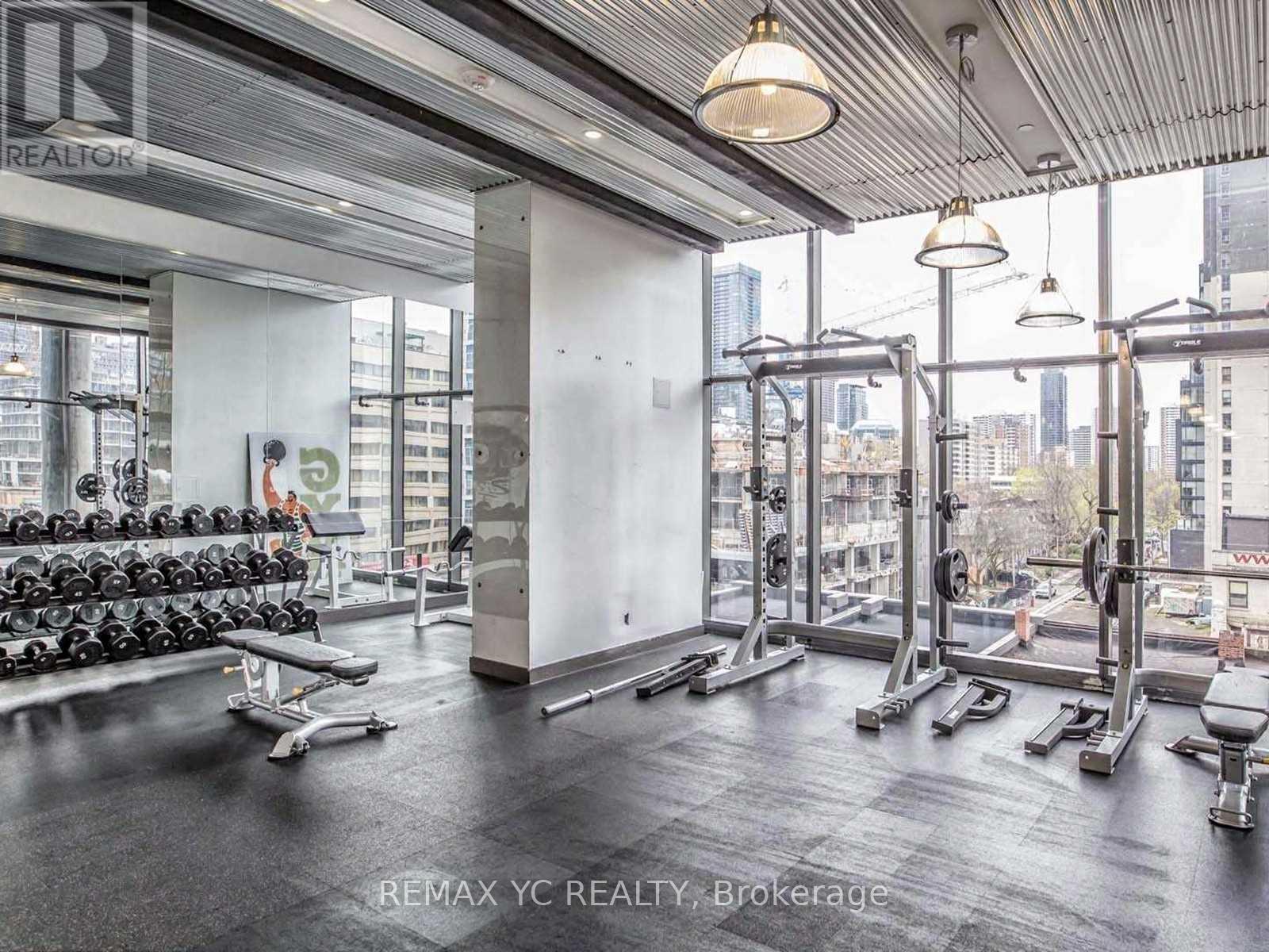 A gym with a view of the city outside the windows.