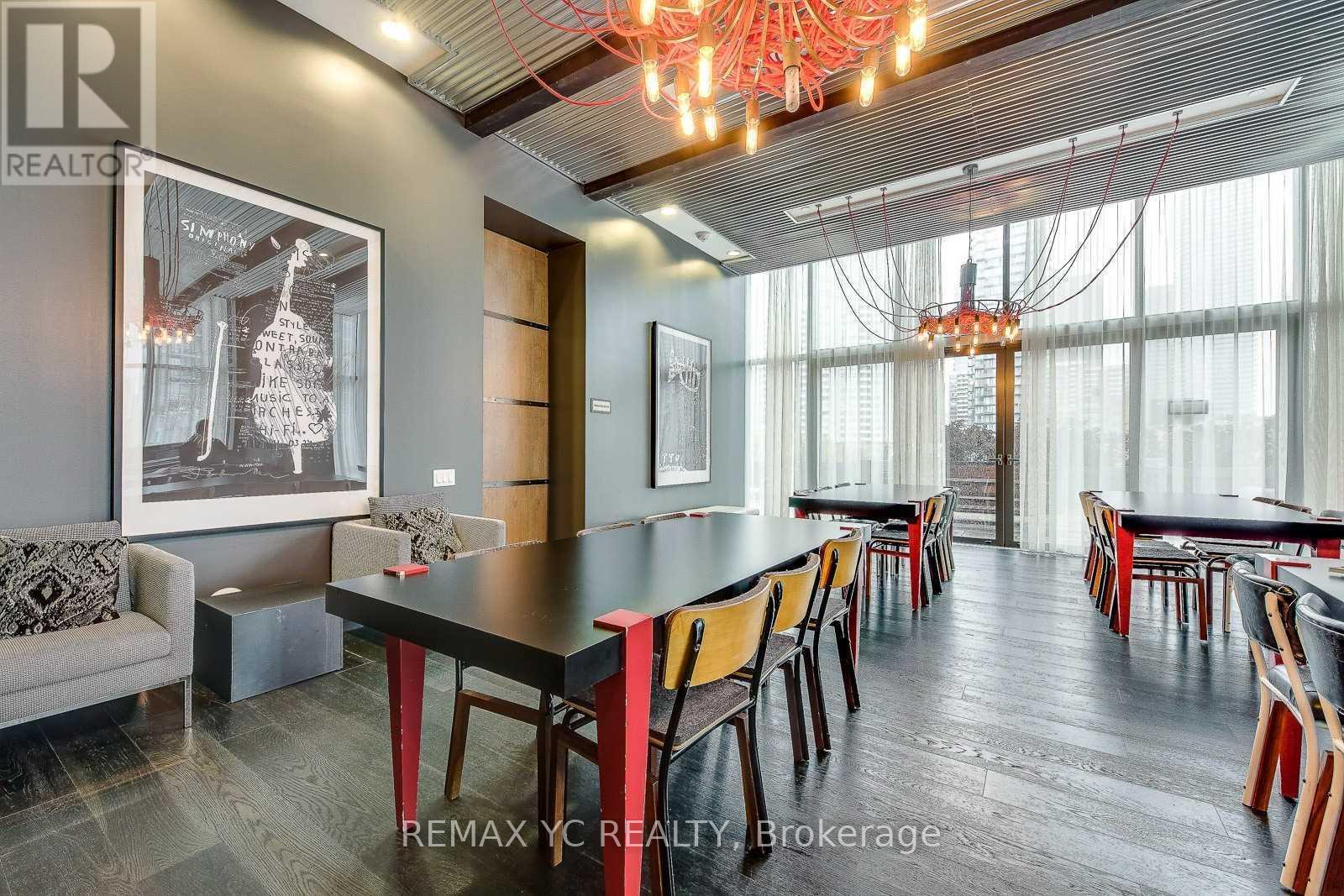 A dining room with a long table and chairs.