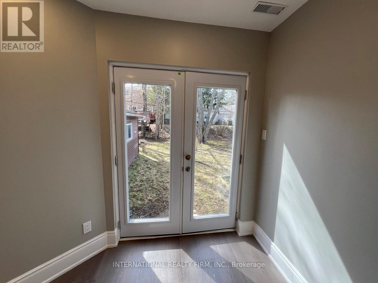 A room with a sliding door leading to a backyard.