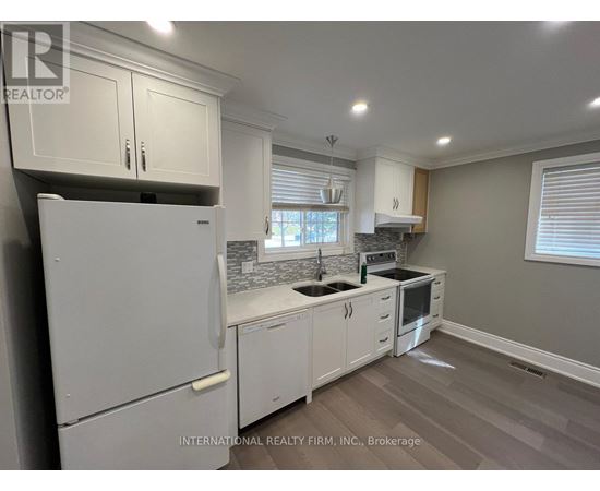 A kitchen with white cabinets and appliances.