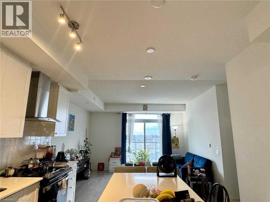 A well-lit kitchen with a dining area in the background.