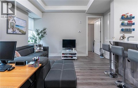 A living room with a grey couch and a wooden table.