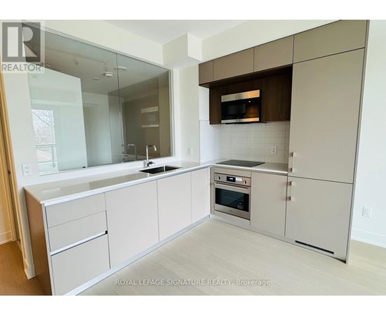A modern kitchen with white cabinets and stainless steel appliances.