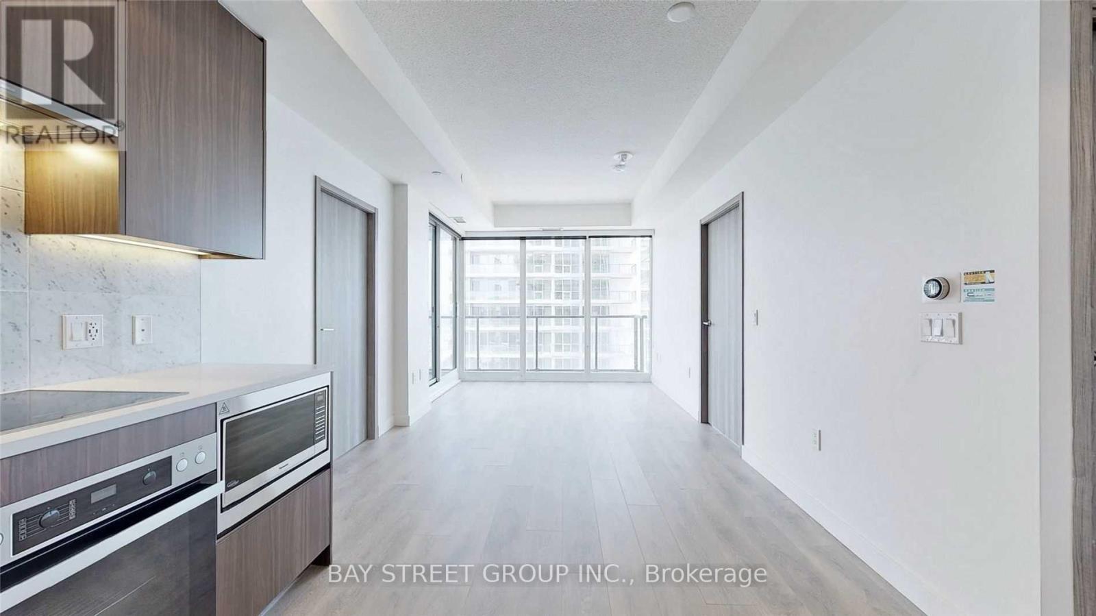 A modern kitchen with wooden cabinets and stainless steel appliances.