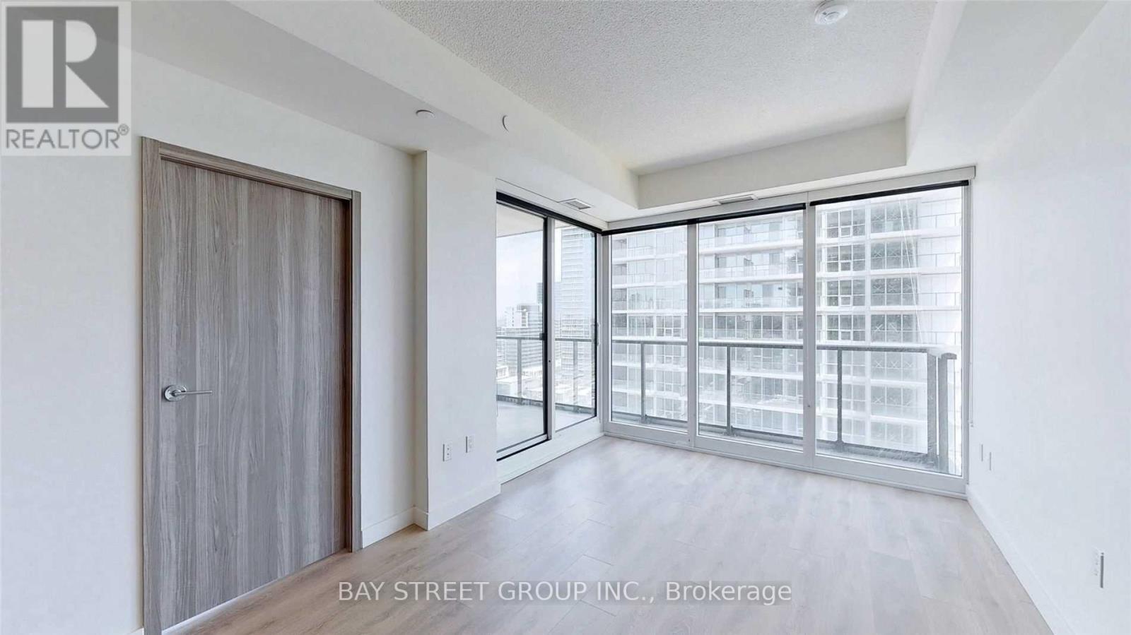 A realtor brochure showing a spacious room with a sliding glass door.