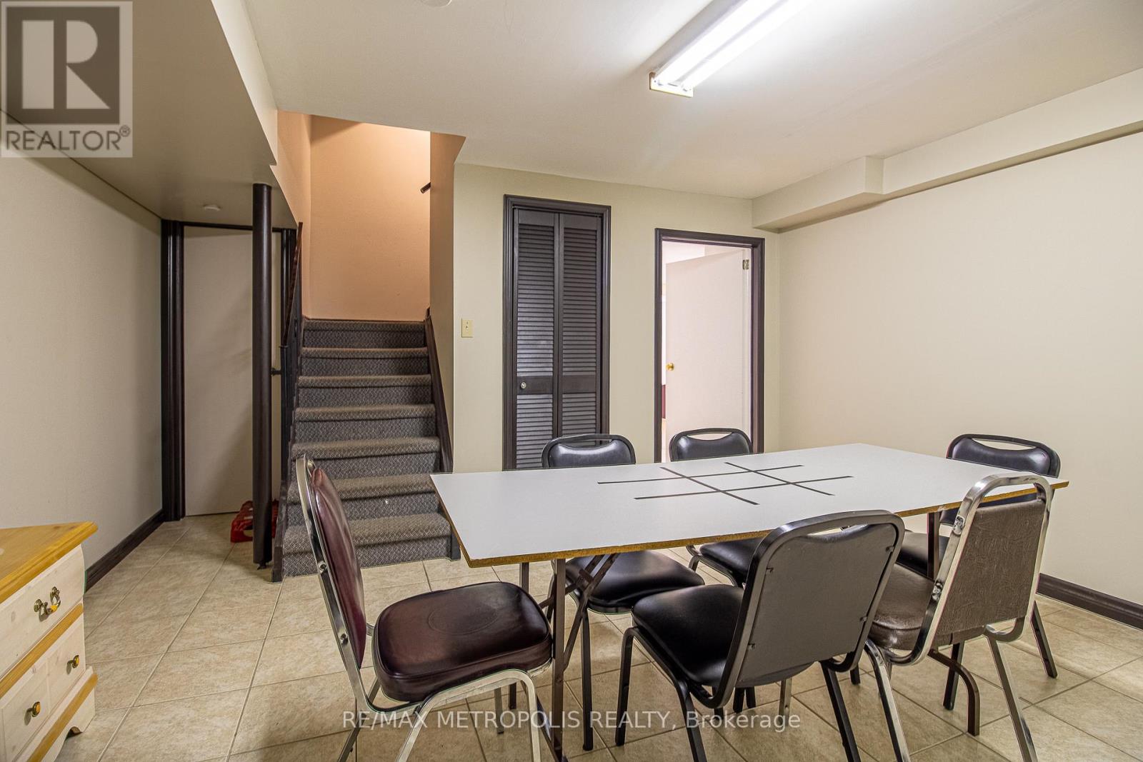 A conference room with a table and chairs is shown.