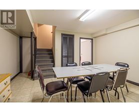 A conference room with a table and chairs is shown.