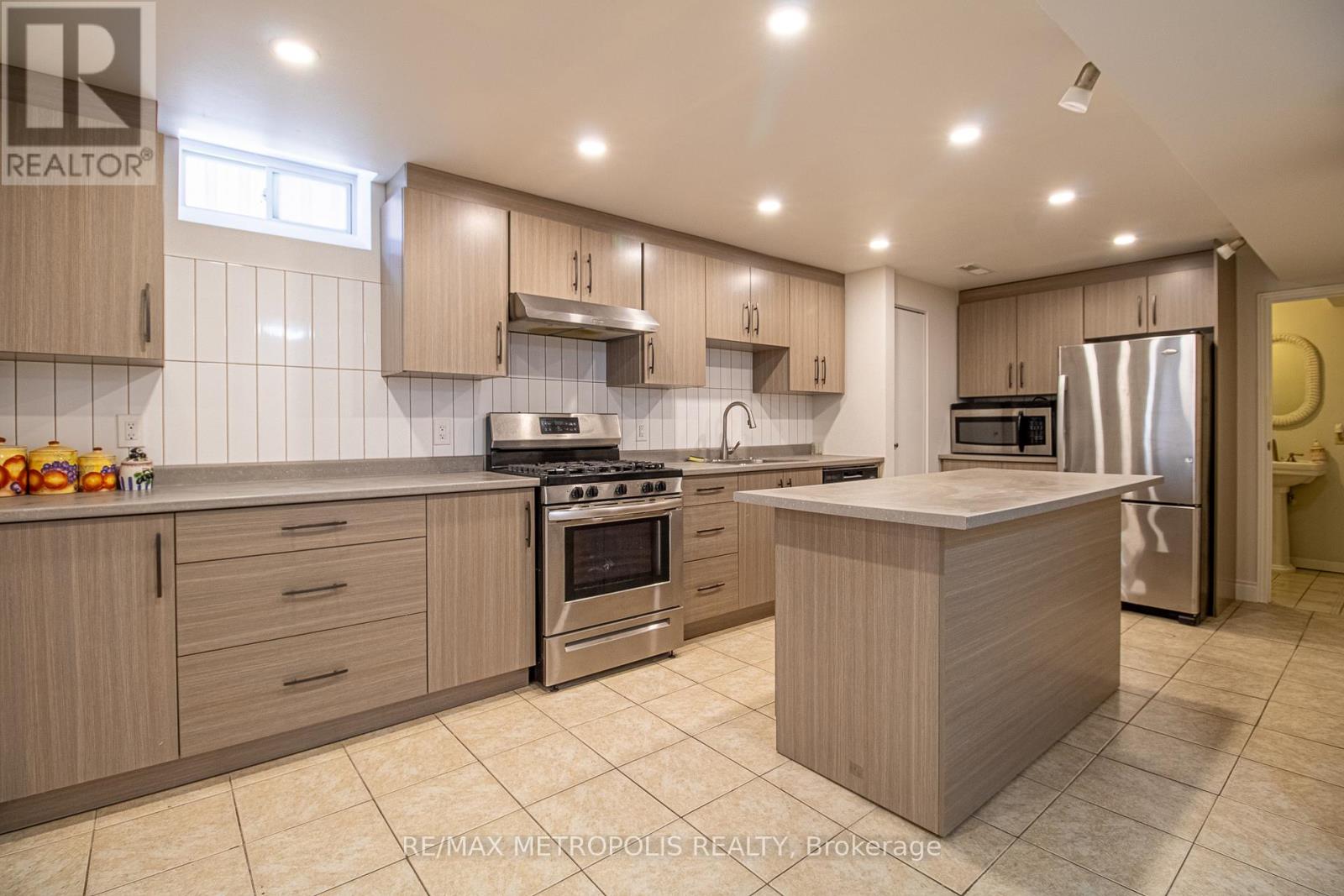 A modern kitchen with wooden cabinets and stainless steel appliances.