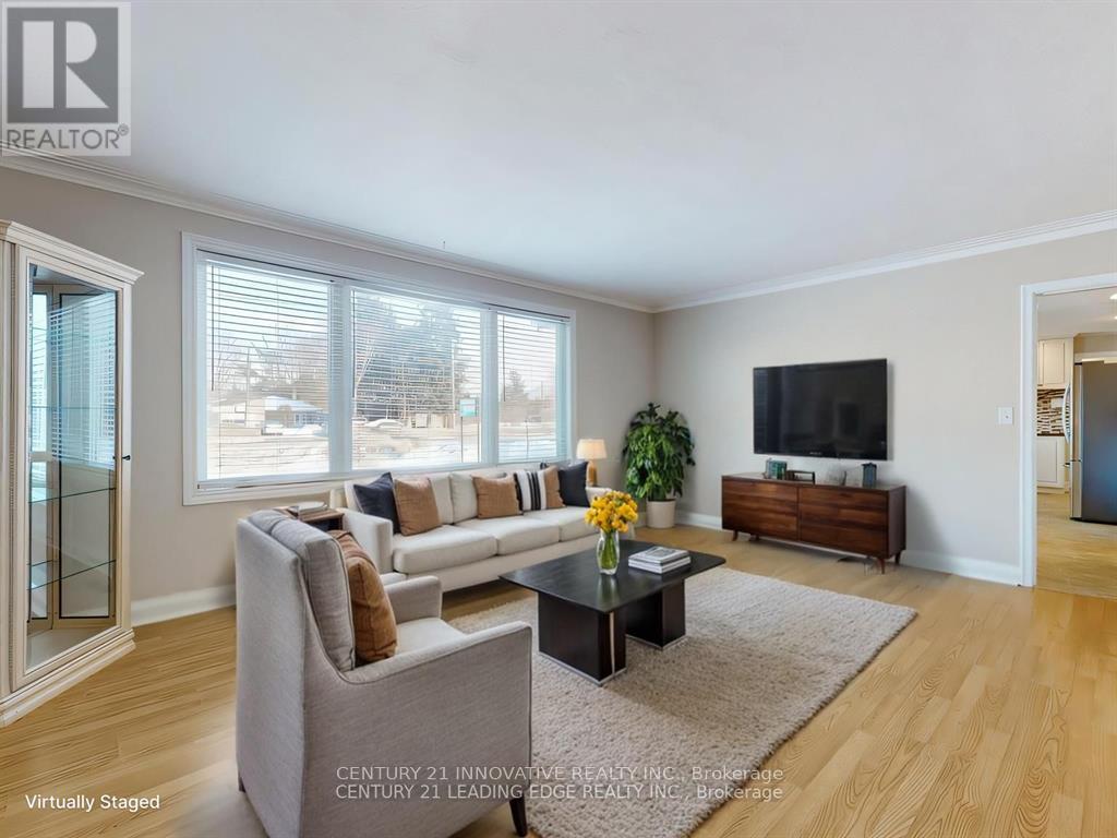 A living room with a grey couch, a coffee table, and a flat screen TV.