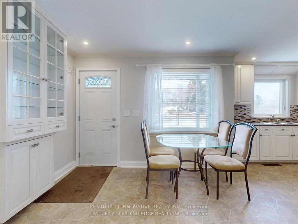 A dining room with a table and chairs.