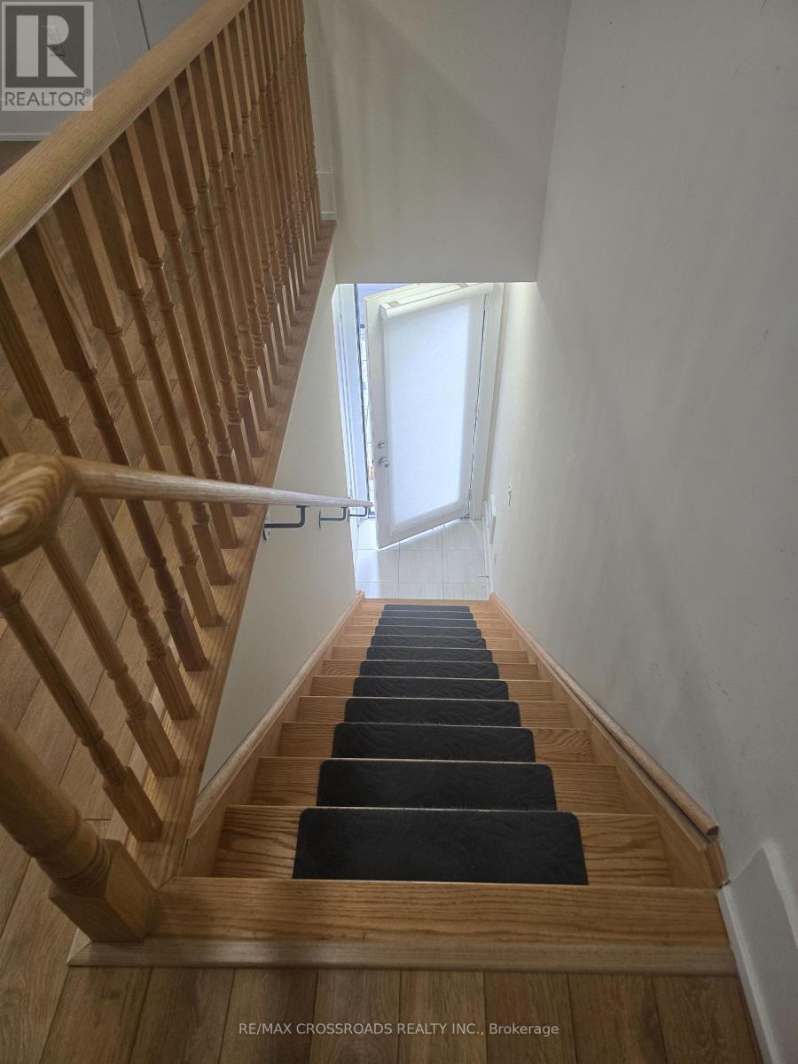 A staircase with wooden steps and a white wall.