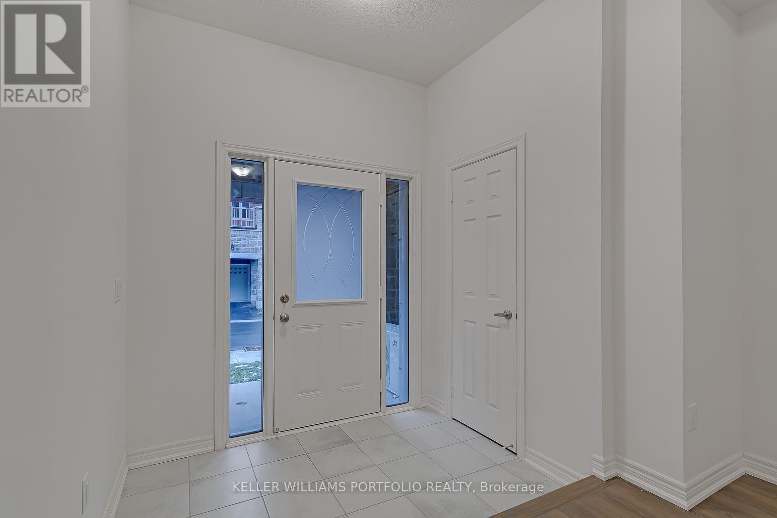 A white room with a door and a window.