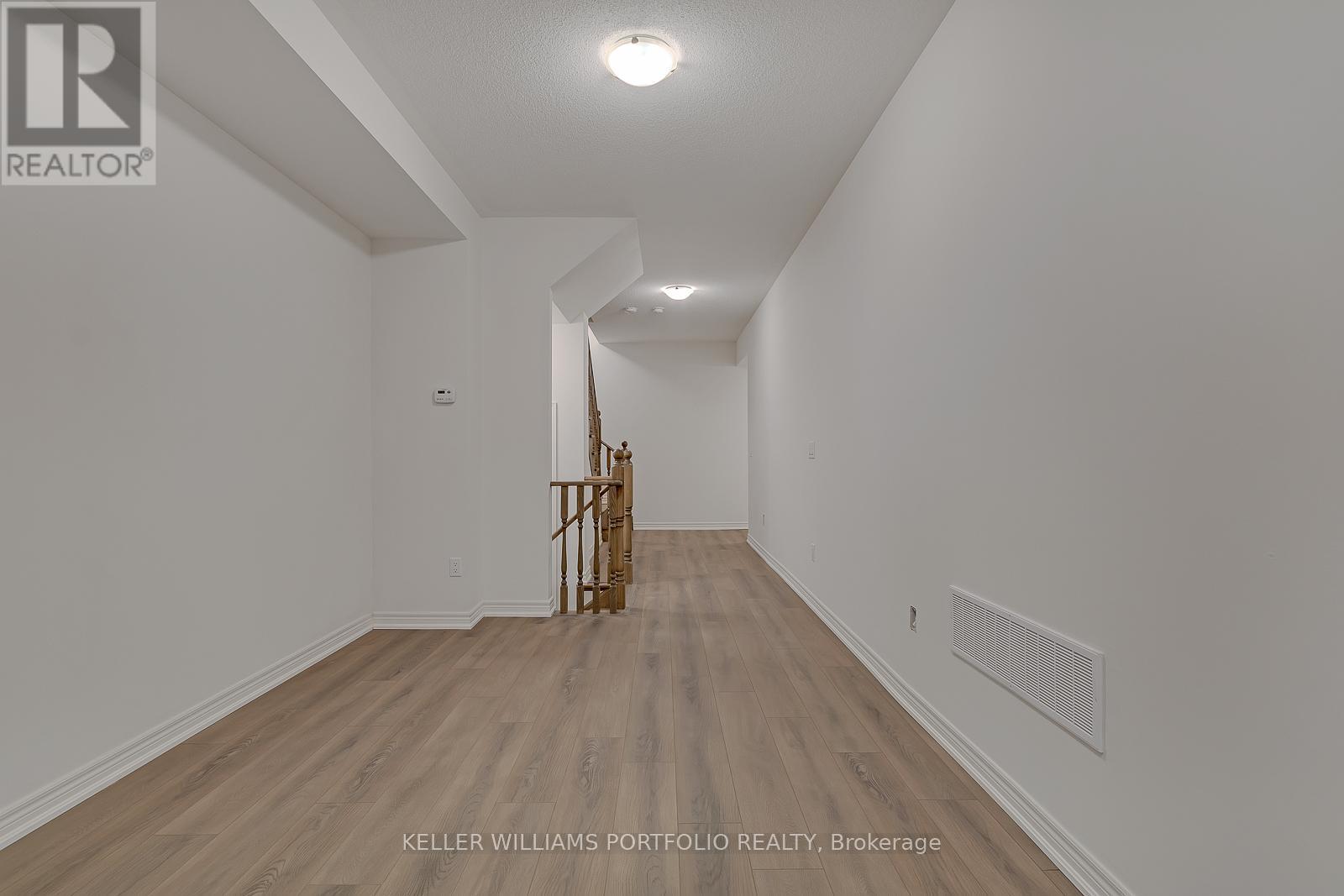 A room with a wooden floor and white walls.