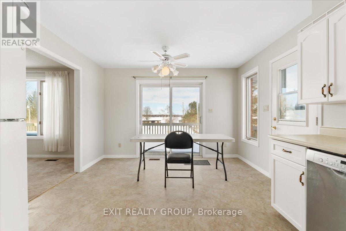 A kitchen with a table and chairs in the middle of the room.