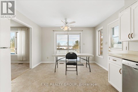 A kitchen with a table and chairs in the middle of the room.