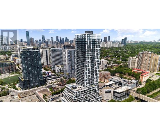 A cityscape with tall buildings and a clear sky.