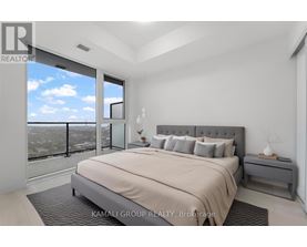 A bedroom with a large bed and a view of the city.