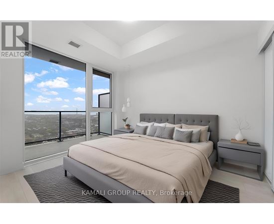 A bedroom with a large bed and a view of the city.