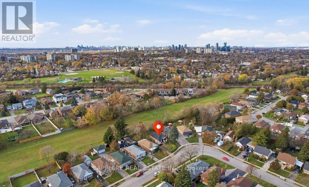 A bird's eye view of a residential area with a red marker indicating a specific location.