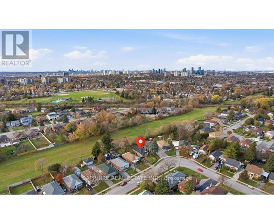 A bird's eye view of a residential area with a red marker indicating a specific location.