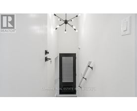 A modern interior with a glass door and a chandelier.