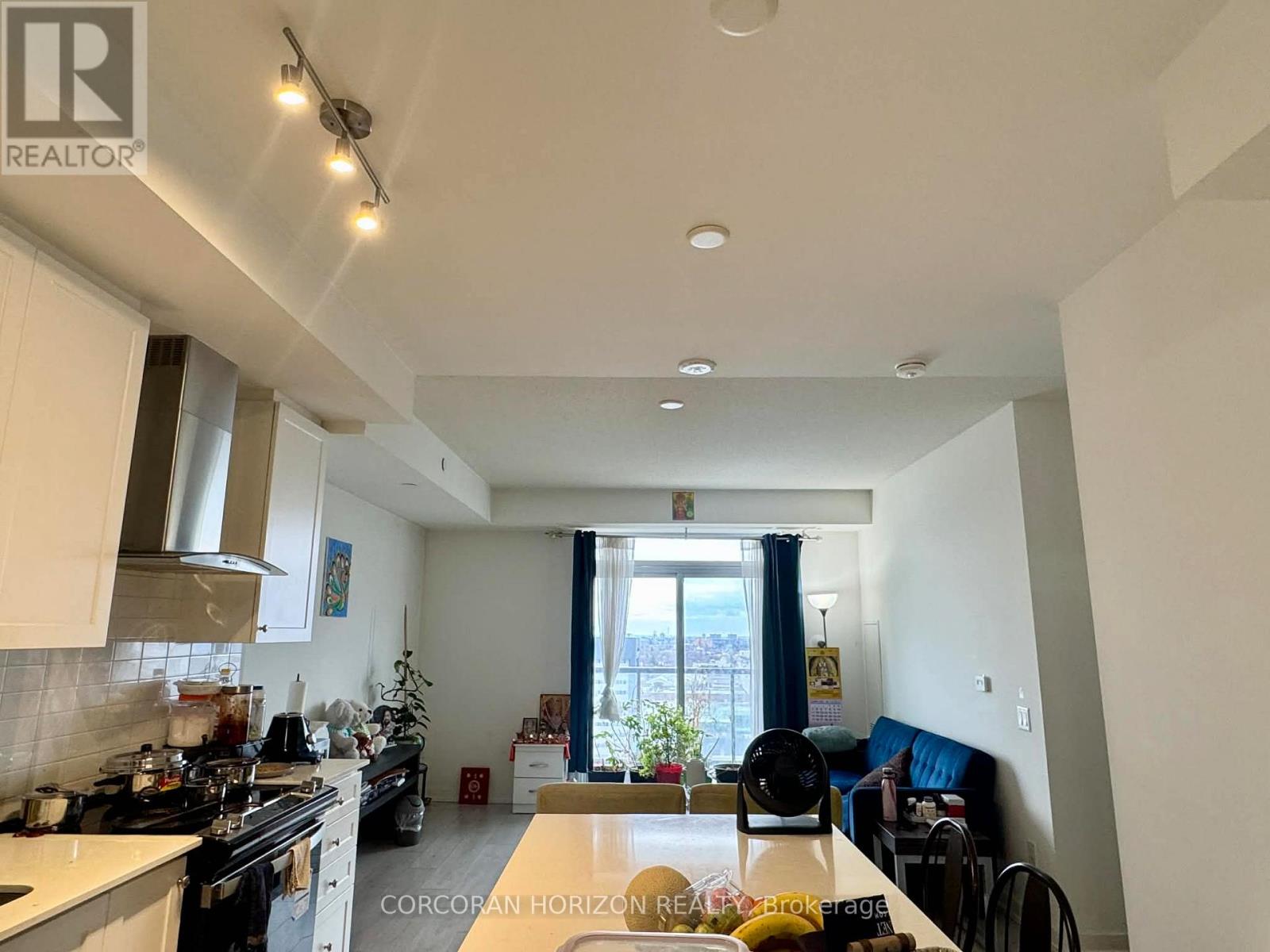 A well-lit kitchen with a dining table and chairs.