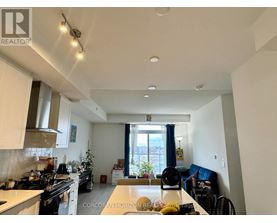 A well-lit kitchen with a dining table and chairs.