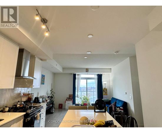 A well-lit kitchen with a dining table and chairs.