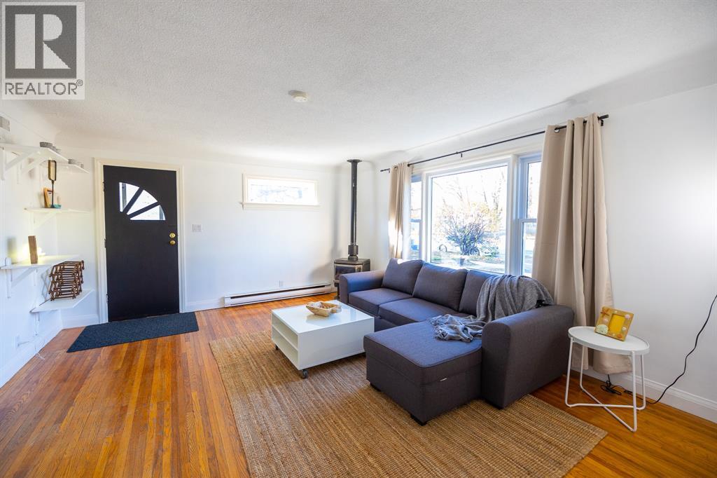A living room with a grey couch and a coffee table.