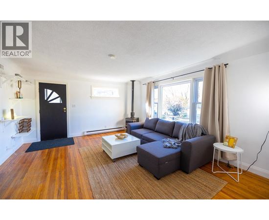 A living room with a grey couch and a coffee table.