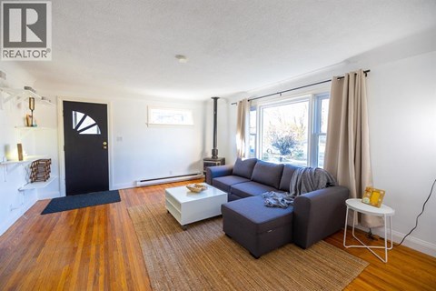 A living room with a grey couch and a coffee table.
