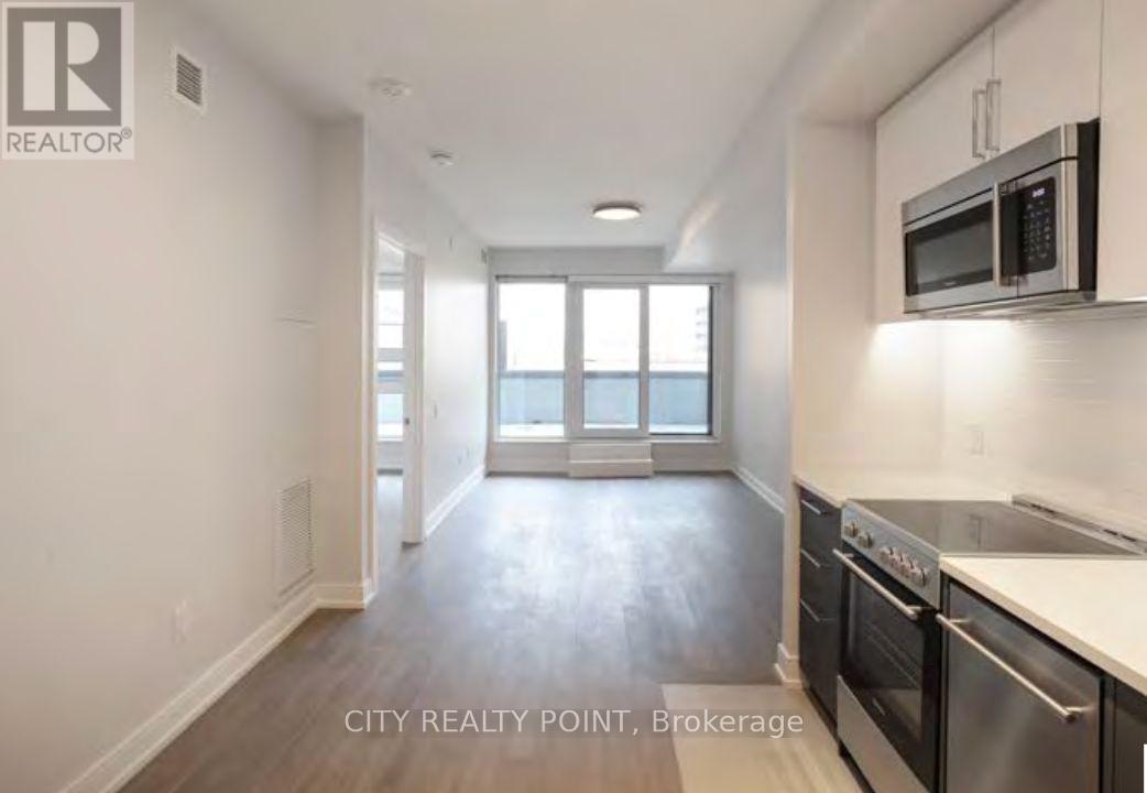 A kitchen area with a microwave and oven installed.