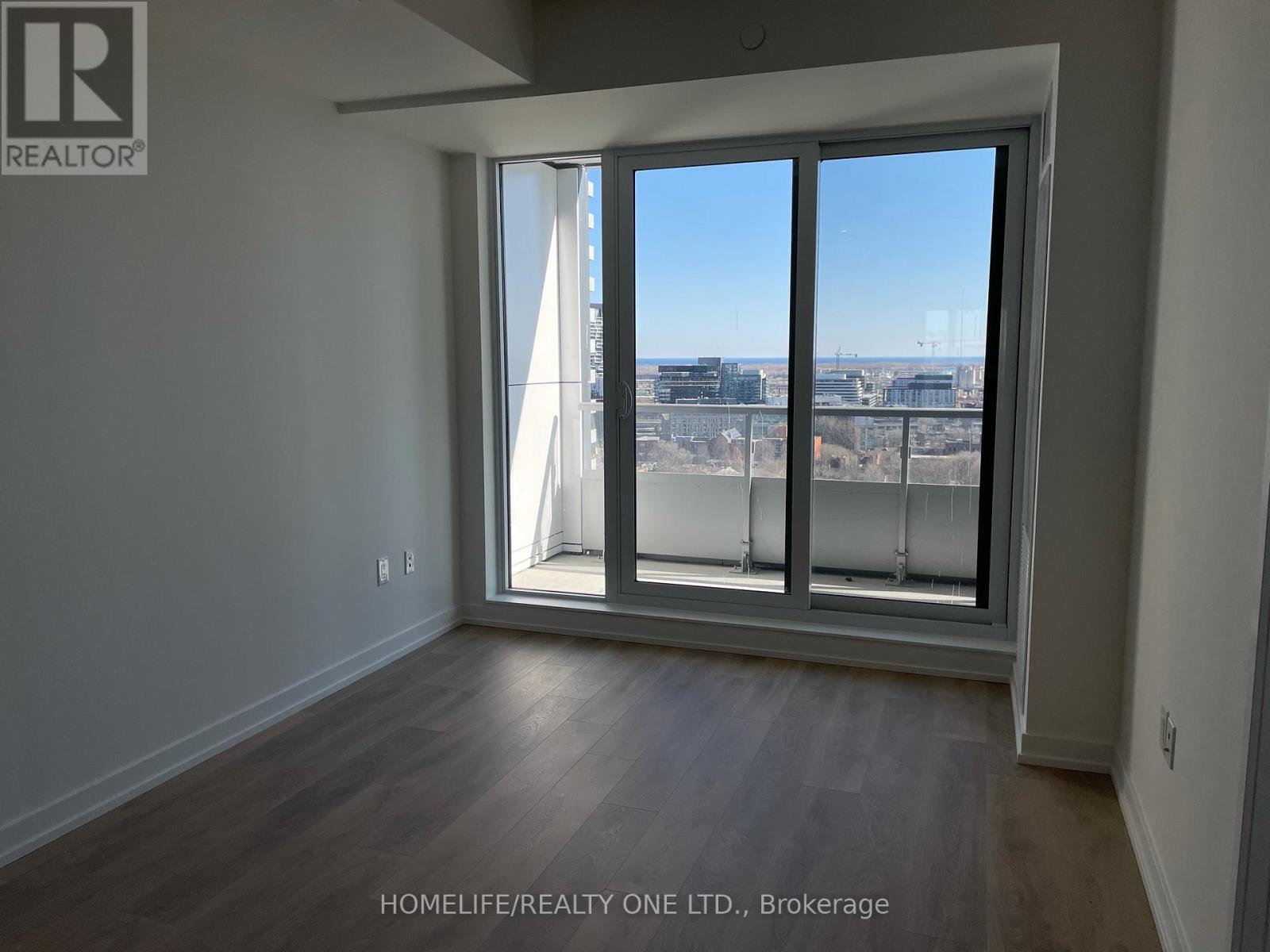 A room with a large window overlooking a cityscape.
