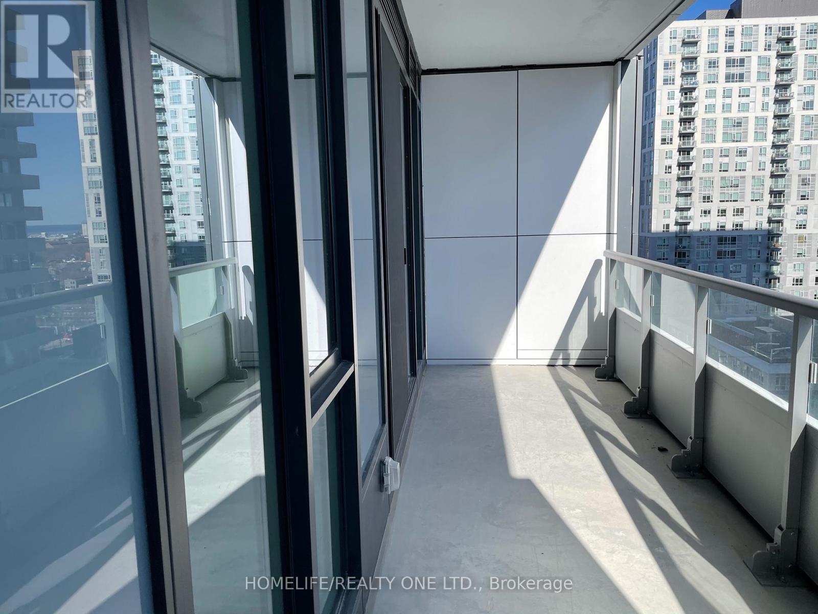 A view from inside a building looking out through a window at a cityscape.